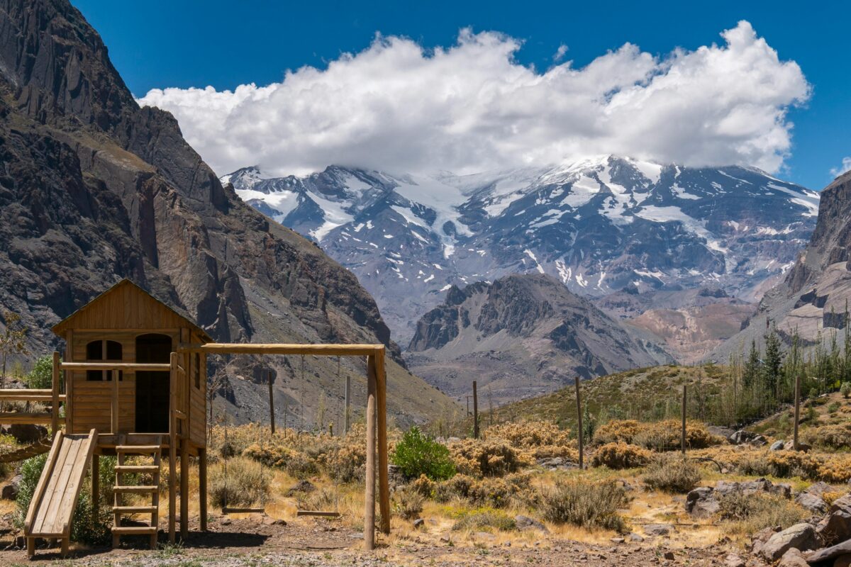 The Andes mountains near Santiago, Chile, with its snow-capped mountains, rolling terrain, and beautiful wooden amphitheater under a brilliant blue sky--perfect for nature lovers going on vacation
